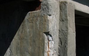 Close up of an eroding cinder block support beam on a bridge. 